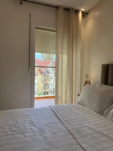a bedroom with a bed and a window with a view at Dar Dina Havre de paix sous les cèdres d'Ifrane in Ifrane