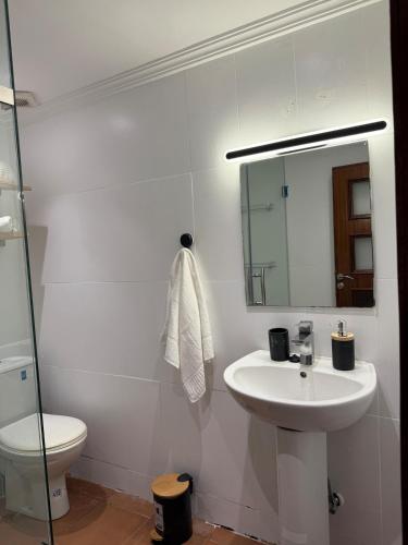 a bathroom with a sink and a toilet and a mirror at Dar Dina Havre de paix sous les cèdres d'Ifrane in Ifrane