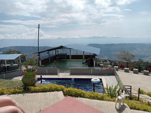 a house with a swimming pool with a view of the mountains at Cabaña El Retiro en Guaduas in Guaduas