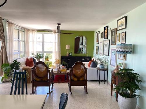 a living room with two chairs and a table at Rama West Residence in Jayuya