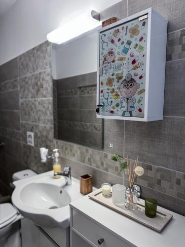 a bathroom with a sink and a mirror at Sofia Luxury Apartments in Lechaio