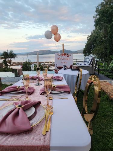 a table with wine glasses and balloons on top of it at Le Bamboo Guest House And Boat Cruise in Hartbeespoort