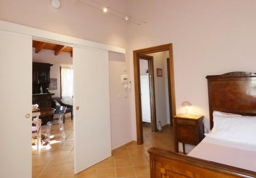 a bedroom with a bed and a living room at Il Laghello Wood House in Framura