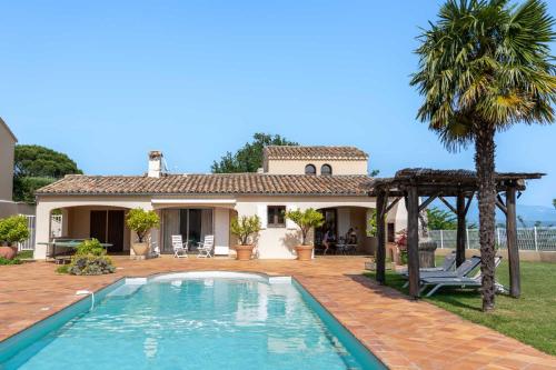 a villa with a swimming pool in front of a house at Villa Lazuel, piscine privée chauffée, vue panoramique et jardin clos in Aubenas