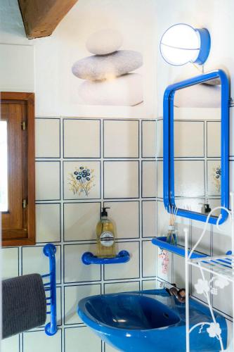 a bathroom with a blue sink and a mirror at Villa Lazuel, piscine privée chauffée, vue panoramique et jardin clos in Aubenas