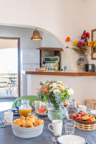 a table topped with plates and bowls of food at Villa Lazuel, piscine privée chauffée, vue panoramique et jardin clos in Aubenas