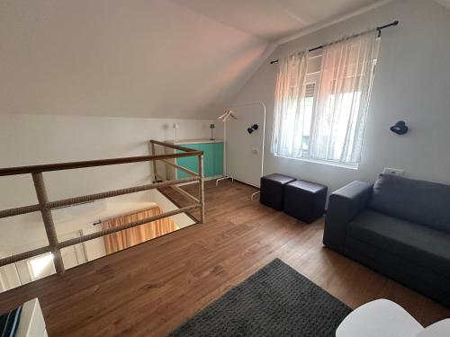 a living room with a staircase and a couch at Villa Popovic - apartments Fruska gora in Sremski Karlovci