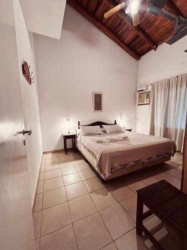 a bedroom with a large bed in a room at Aguasanas casas termales Chajari in Chajarí