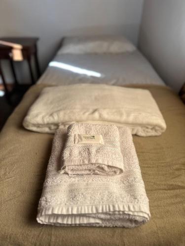 two beds with towels sitting on top of them at Aguasanas casas termales Chajari in Chajarí