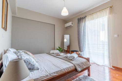a bedroom with a bed and a large window at matarooms in Preveza