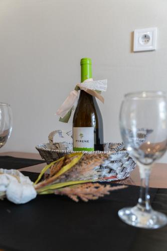 a bottle of wine and a glass on a table at matarooms in Preveza