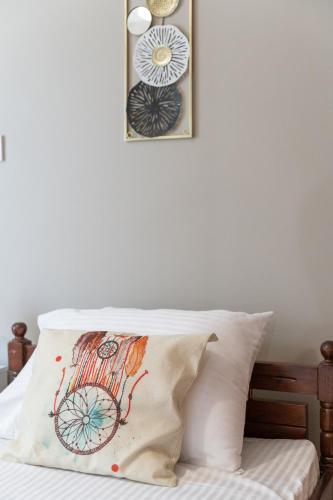 a pillow on a bed with two pictures on the wall at matarooms in Preveza