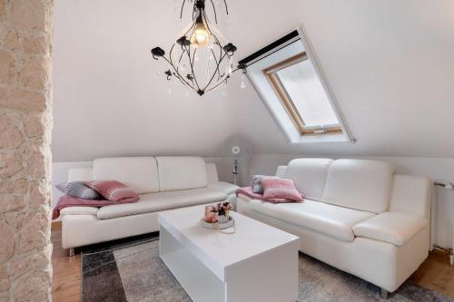 a living room with two white couches and a table at 3 Raum Ferienwohnung Im 1 Og in Cuxhaven