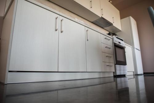 a kitchen with white cabinets and a stove at Sofia Luxury Apartments in Lechaio