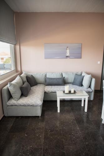 a living room with a couch and a table at Sofia Luxury Apartments in Lechaio