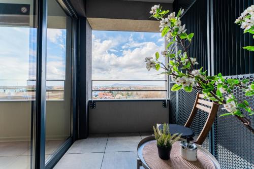 a balcony with a table and chairs and windows at Flex SelfCheckIns 142 - Zagreb - Bedroom - Garage - Loggia in Zagreb