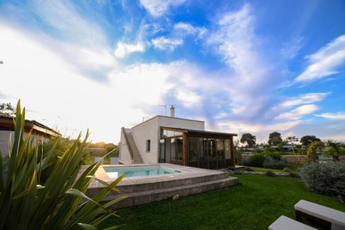 a house with a swimming pool in a yard at Masseria Casina Fiocca in Pisignano