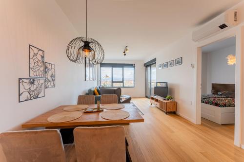 a dining room and living room with a table and chairs at Flex SelfCheckIns 142 - Zagreb - Bedroom - Garage - Loggia in Zagreb
