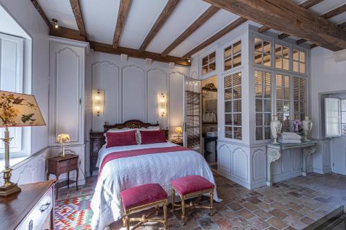 une chambre avec un grand lit et deux chaises dans l'établissement Gîte de l'Antiquaire au cœur de la Citadelle Blaye, à Blaye