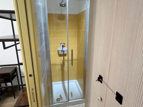 a shower with a glass door in a room at Annarè House in Ischia