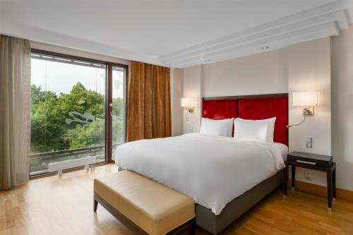 a bedroom with a large bed and a large window at Radisson Blu Elizabete Hotel, Riga in Rīga