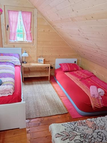 a bedroom with two beds in a attic at Vile Bliznakinje in Vinci