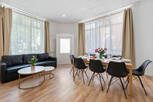 a living room with a couch and a table and chairs at Holiday 33 Apartment O, 4 rooms and whirlpool in Berlin
