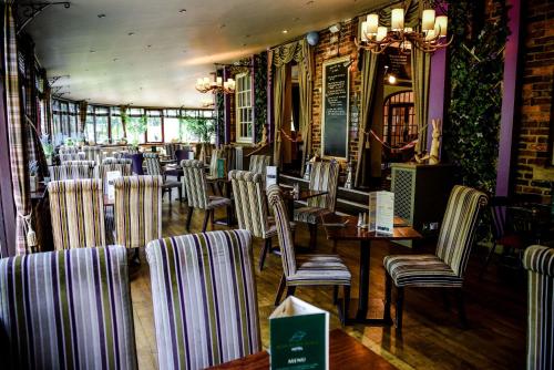 a restaurant with chairs and tables in a room at Bowburn Hall Hotel in Durham