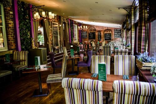 a restaurant with chairs and tables in a room at Bowburn Hall Hotel in Durham