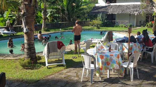 a group of people in the swimming pool at a resort at Indri Lodge in Andasibe