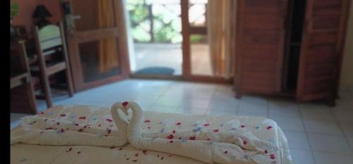 a towel shaped like a swan sitting on a floor at Indri Lodge in Andasibe