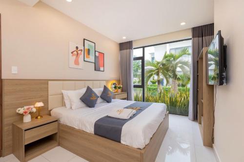 a bedroom with a large bed and a television at ARIA Resort Vung Tau S01 in Vung Tau