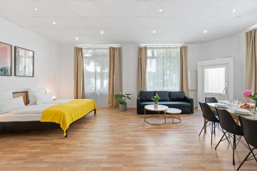 a bedroom with a bed and a dining room at Holiday 33 Apartment O, 4 rooms and whirlpool in Berlin