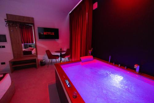 a pool table in a living room with red lighting at 5 Stars - Exclusive Luxury Suites with a jacuzzi in Trapani