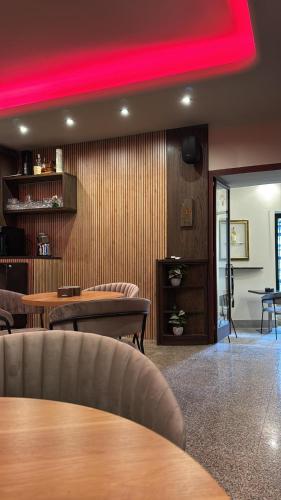 a room with tables and chairs and a red light at Camere del Corso in Tempio Pausania