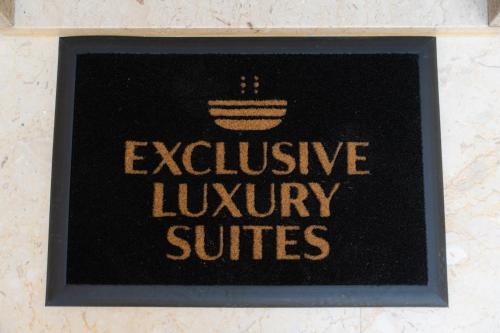 a sign on a wall with the words inclusive luxury suites at 5 Stars - Exclusive Luxury Suites with a jacuzzi in Trapani