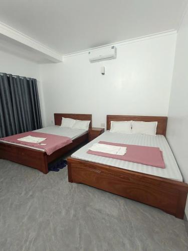 Cama o camas de una habitación en Tigon Hotel