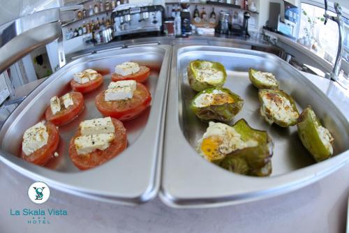 a plate of food with tomatoes and cheese at La SkalaVista in Skala Kefalonias
