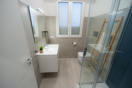 a bathroom with a shower and a sink and a toilet at 5 Stars - Exclusive Luxury Suites with a jacuzzi in Trapani