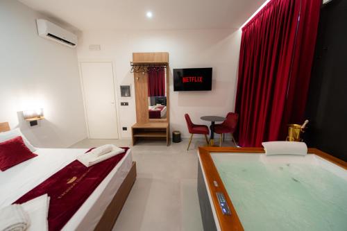 a room with a bed and a tub in it at 5 Stars - Exclusive Luxury Suites with a jacuzzi in Trapani