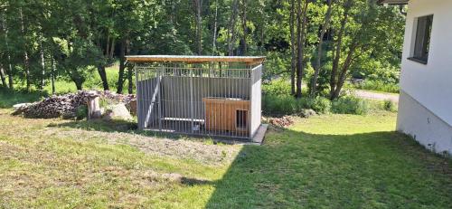 a bird cage in the yard of a house at Chata Henry in Krásná