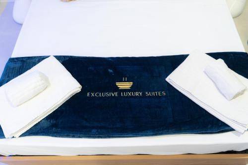 a bed with a blue blanket and two white towels at 5 Stars - Exclusive Luxury Suites with a jacuzzi in Trapani