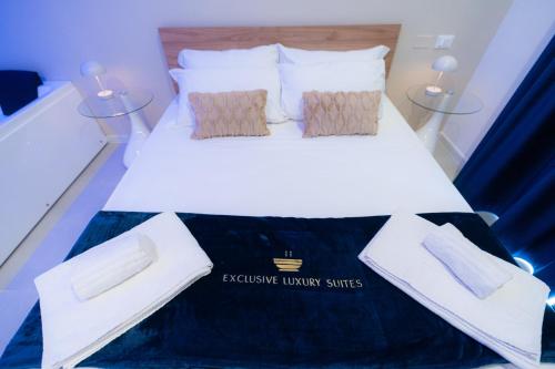 a white bed with two pillows on top of it at 5 Stars - Exclusive Luxury Suites with a jacuzzi in Trapani
