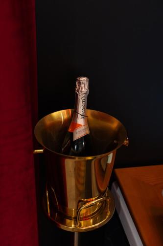 a bottle of wine in a metal bucket at 5 Stars - Exclusive Luxury Suites with a jacuzzi in Trapani