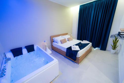 a bedroom with a bath tub and a bed and a bath tub at 5 Stars - Exclusive Luxury Suites with a jacuzzi in Trapani