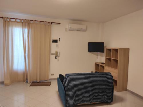 a living room with a couch and a television at Bellavista Apartments in Scopello