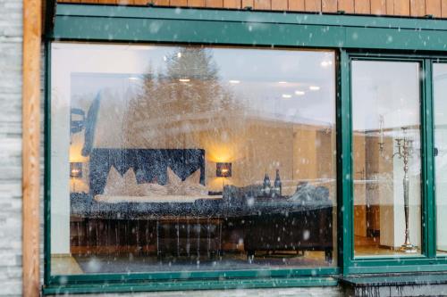 a window of a building with snow on it at Silberleithen Estate in Biberwier