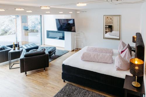 a bedroom with a bed and a living room at Silberleithen Estate in Biberwier