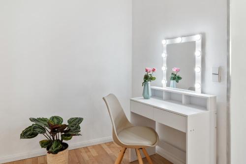 a white desk with a chair and a mirror at Holiday 33 Apartment O, 4 rooms and whirlpool in Berlin