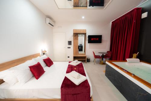 a bedroom with a large bed and a bath tub at 5 Stars - Exclusive Luxury Suites with a jacuzzi in Trapani